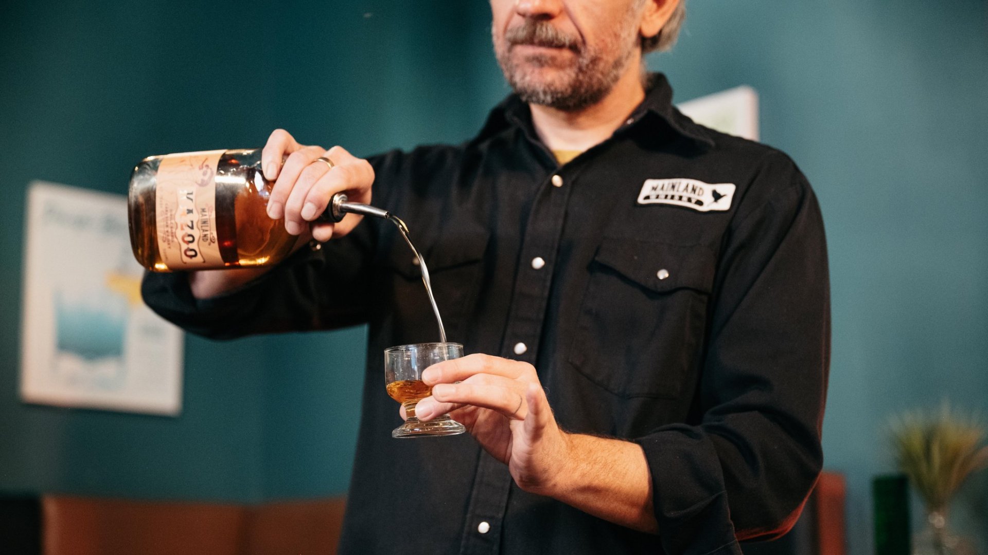 Art of Distilling The Mainland Whisky Story Owner Steve pours a glass of signature whisky