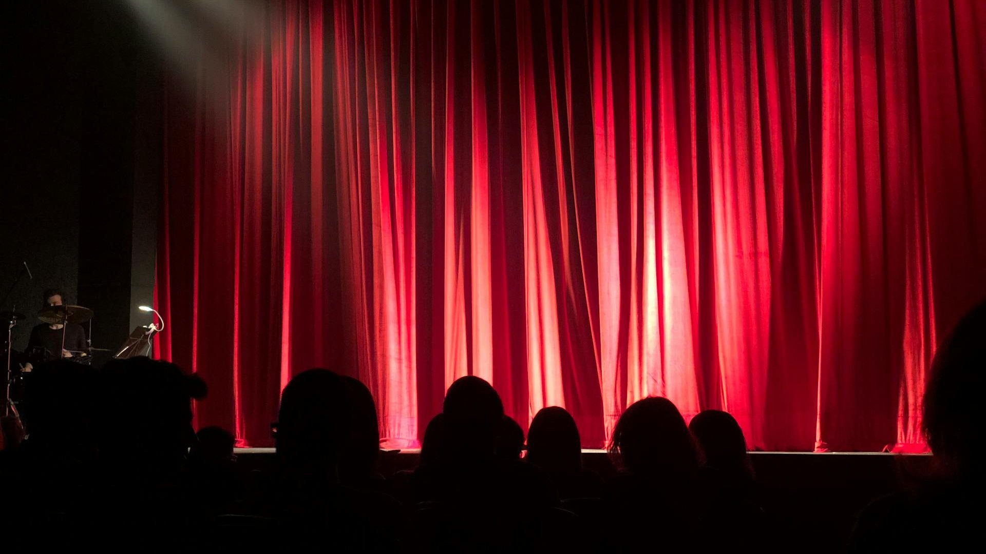 A stage with a red curtain background ready to welcome a performer stock monica 713149